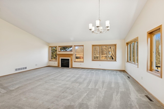 unfurnished living room featuring light carpet, a glass covered fireplace, visible vents, and lofted ceiling