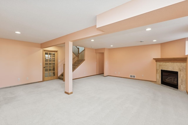 finished basement featuring stairway, baseboards, visible vents, and recessed lighting