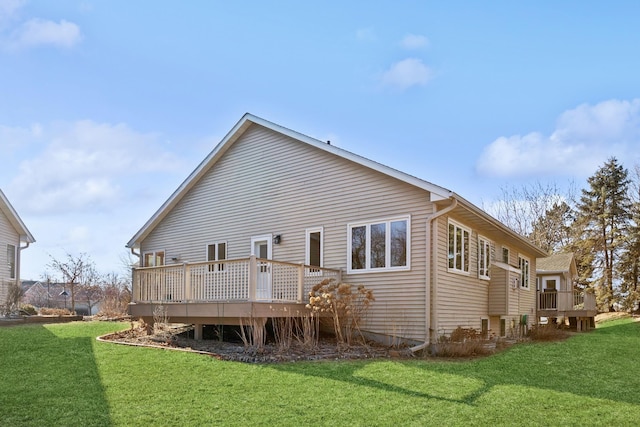 rear view of property with a lawn and a deck