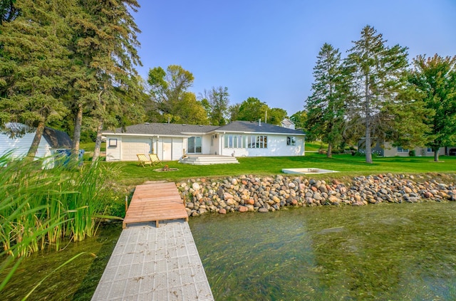 back of house with a lawn
