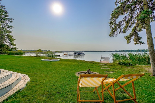 view of yard with a water view and an outdoor fire pit