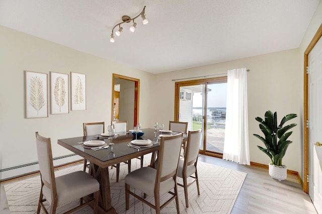 dining room with light wood finished floors and baseboards
