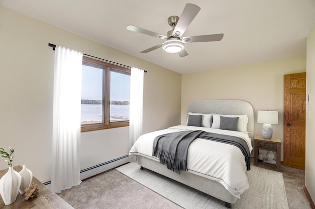 bedroom with baseboard heating, a water view, light colored carpet, and a ceiling fan