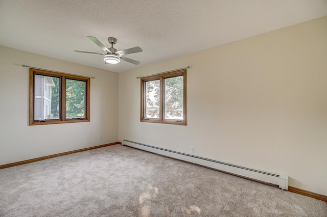 carpeted empty room with baseboard heating, baseboards, a textured ceiling, and a ceiling fan