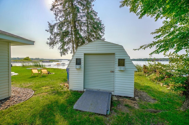 view of shed with a water view