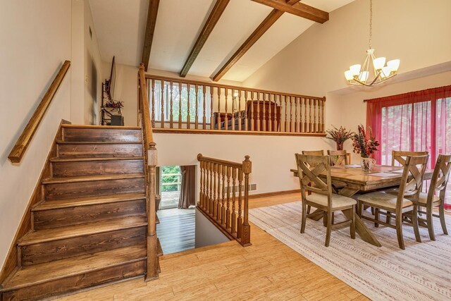 6645 Lancaster Ln N, Maple Grove, MN 55369 - dining room featuring a chandelier, beam ceiling, wood finished floors, and high vaulted ceiling