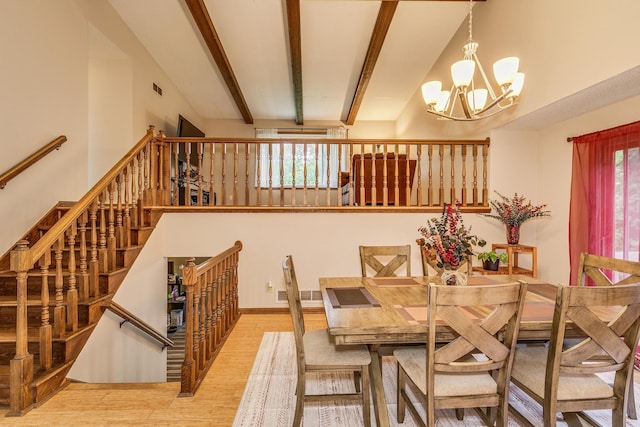 6645 Lancaster Ln N, Maple Grove, MN 55369 - dining room featuring a chandelier, wood finished floors, a high ceiling, and stairs