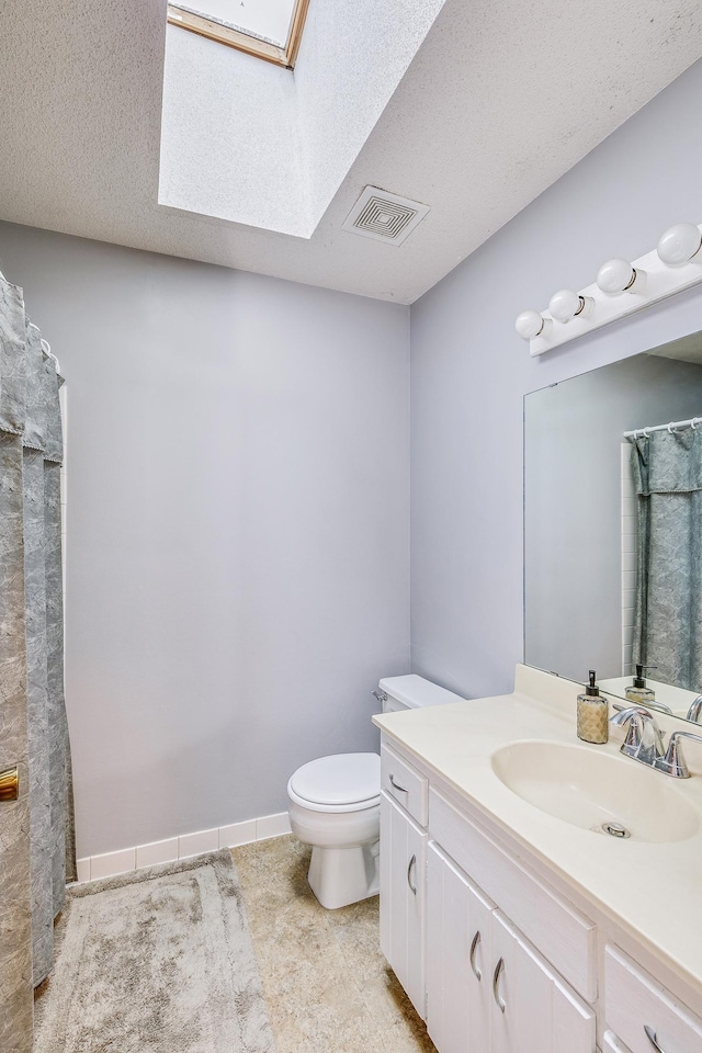6645 Lancaster Ln N, Maple Grove, MN 55369 - bathroom with vanity, a skylight, a textured ceiling, tile patterned floors, and a shower with curtain