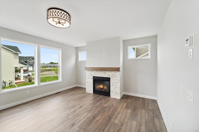 unfurnished living room with a fireplace and light hardwood / wood-style flooring