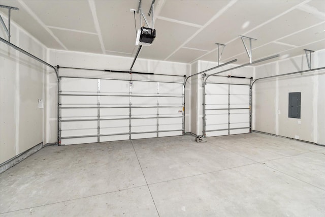 garage with a garage door opener and electric panel