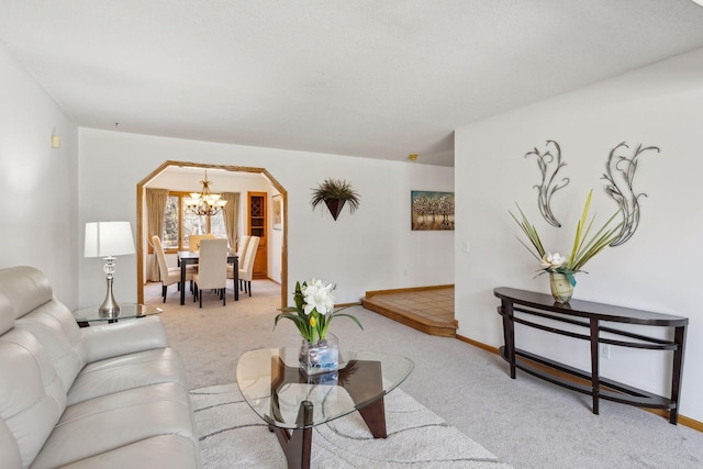 living room with light carpet and a notable chandelier