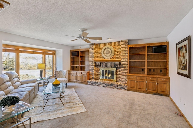 carpeted living room featuring ceiling fan, a brick fireplace, and a textured ceiling