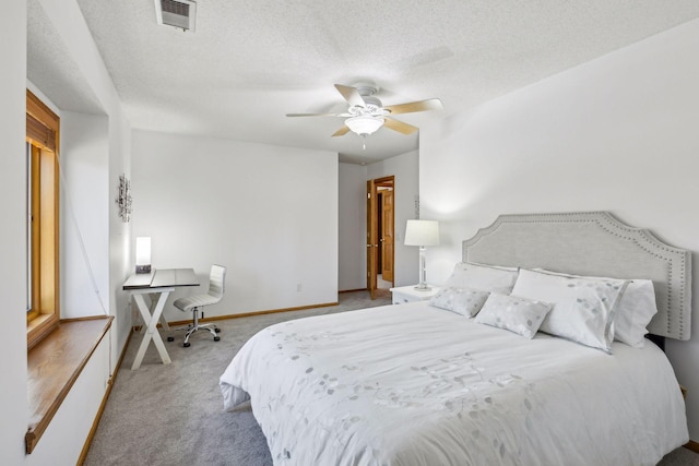 carpeted bedroom with ceiling fan and a textured ceiling