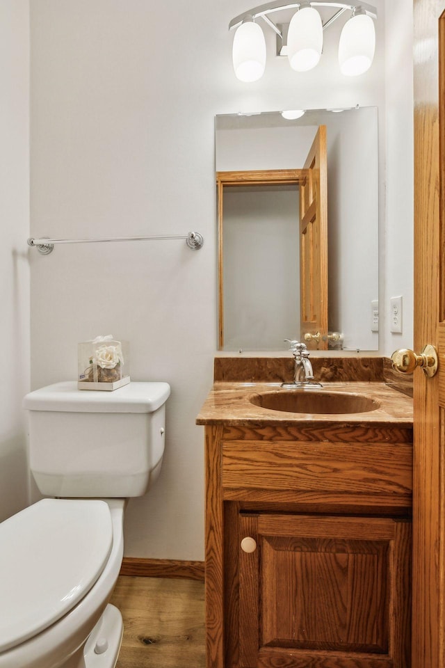 bathroom with vanity, hardwood / wood-style flooring, and toilet