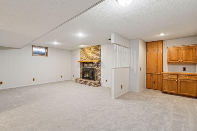 unfurnished living room with a fireplace, light colored carpet, and a textured ceiling