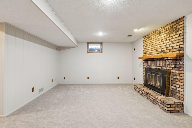 unfurnished living room with carpet floors, a brick fireplace, and a textured ceiling