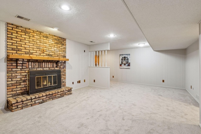 unfurnished living room featuring a brick fireplace, carpet floors, and a textured ceiling