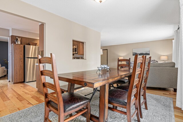 dining space with light wood finished floors