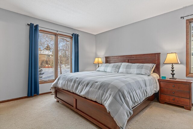 bedroom featuring baseboards and light colored carpet