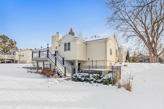 view of front of house with a chimney and stairway