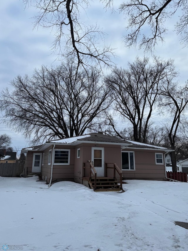 view of snow covered rear of property