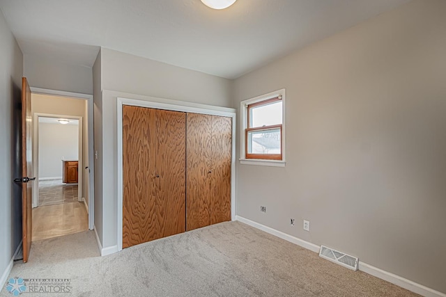 unfurnished bedroom featuring a closet and carpet flooring