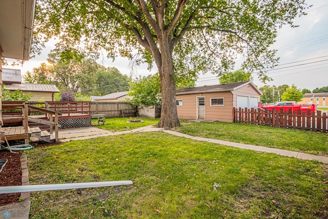 view of yard featuring a garage, an outdoor structure, and a deck