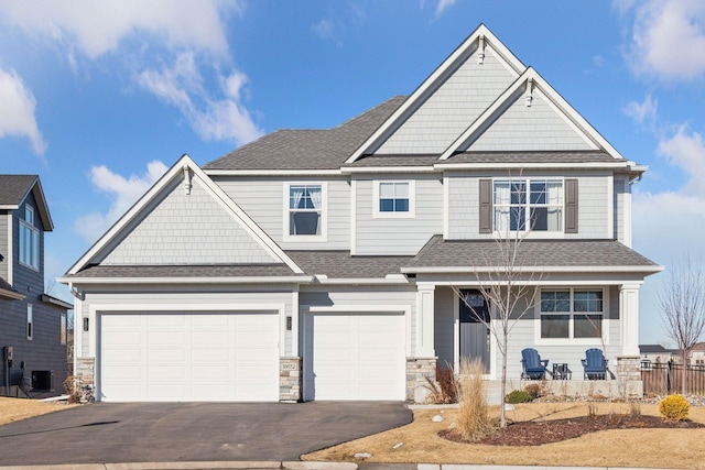 craftsman-style home with a garage and central air condition unit