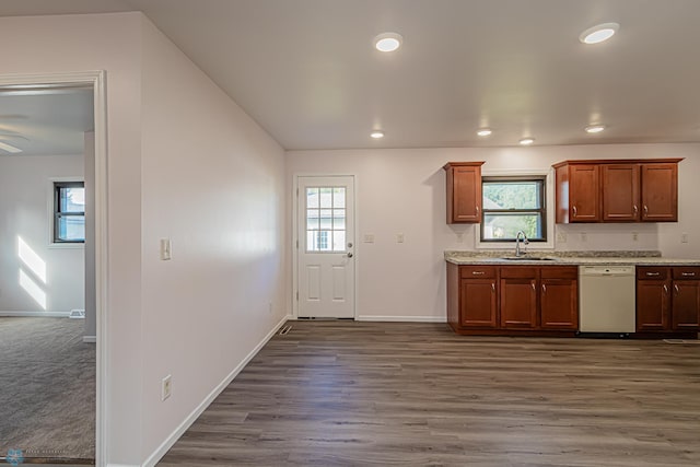 kitchen with sink, dark wood-type flooring, and white dishwasher