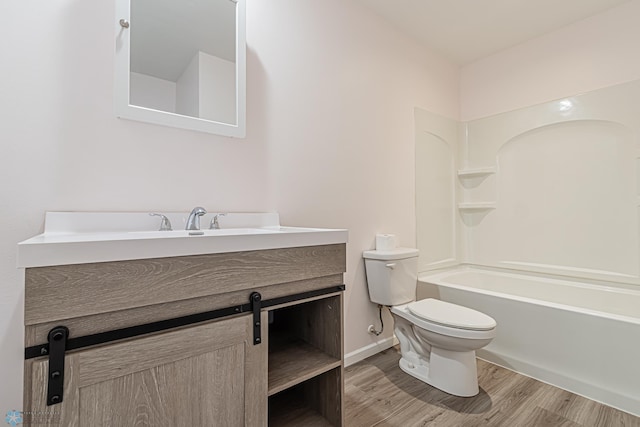 full bathroom with hardwood / wood-style flooring, vanity, toilet, and  shower combination