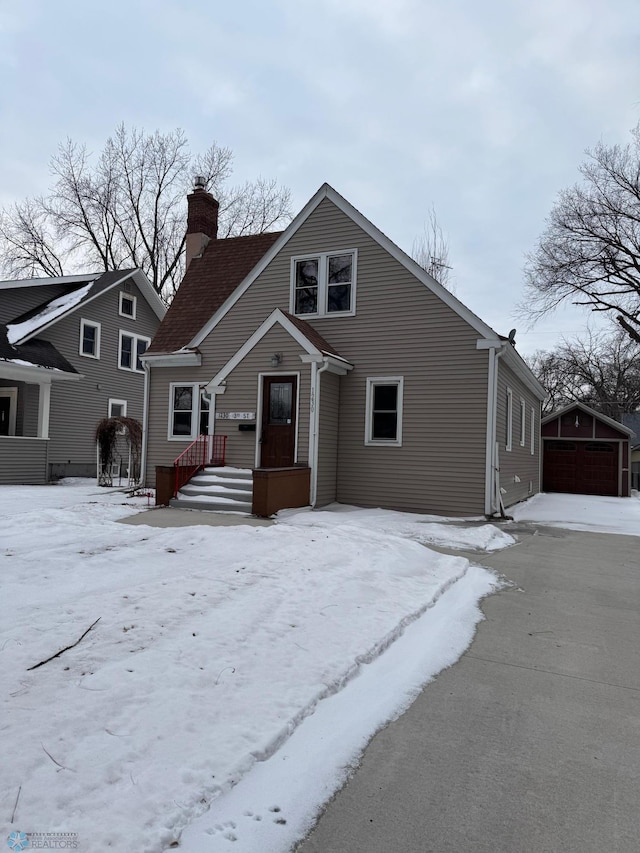 view of front of property featuring a garage and an outdoor structure