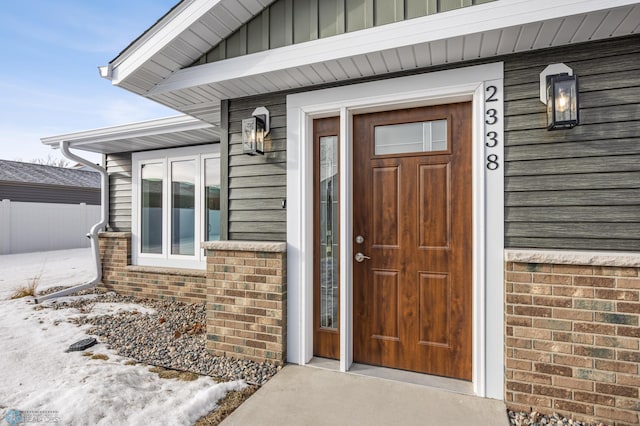 view of snow covered property entrance