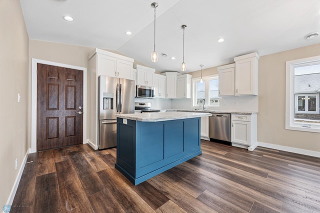 kitchen with white cabinetry, pendant lighting, stainless steel appliances, and a center island