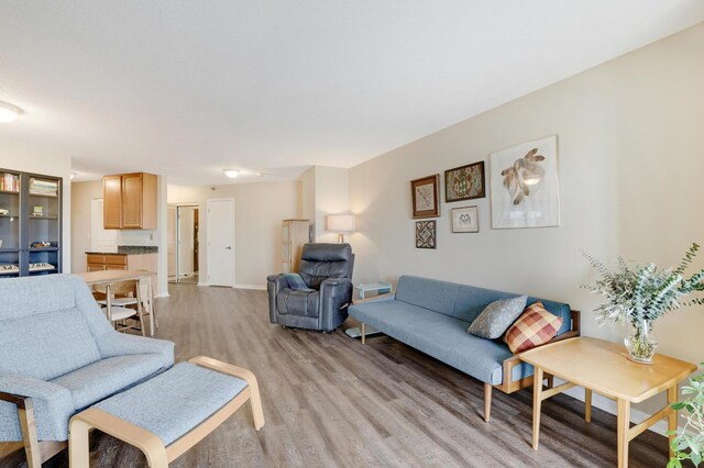 living area with light wood finished floors and baseboards