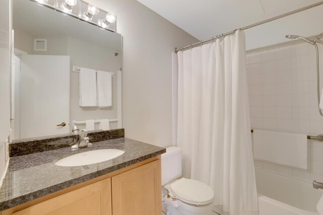 full bath with toilet, vanity, visible vents, and shower / tub combo with curtain