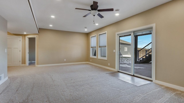 empty room featuring light carpet and ceiling fan