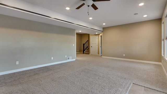 empty room featuring light carpet and ceiling fan