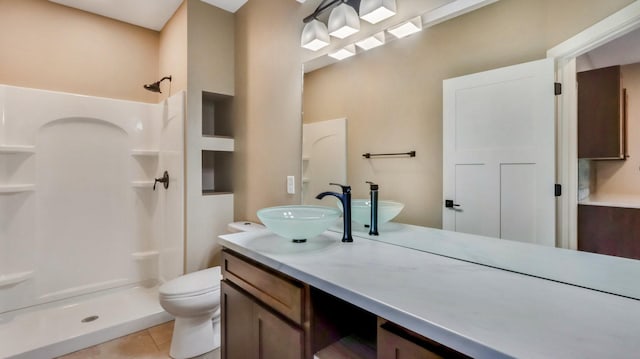 bathroom with walk in shower, tile patterned floors, toilet, and vanity