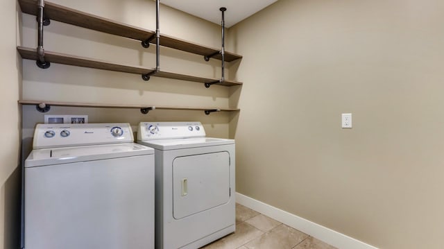 laundry room featuring light tile patterned flooring and washer and dryer