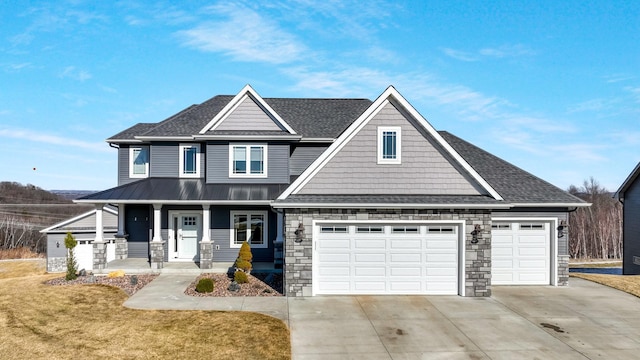 craftsman house with a garage, covered porch, and a front yard