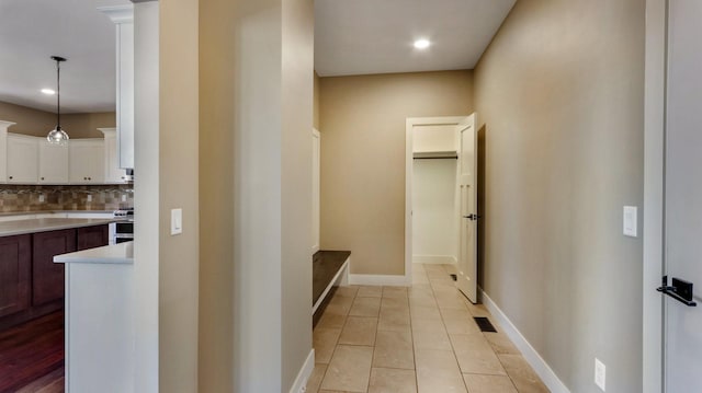 hallway featuring light tile patterned floors