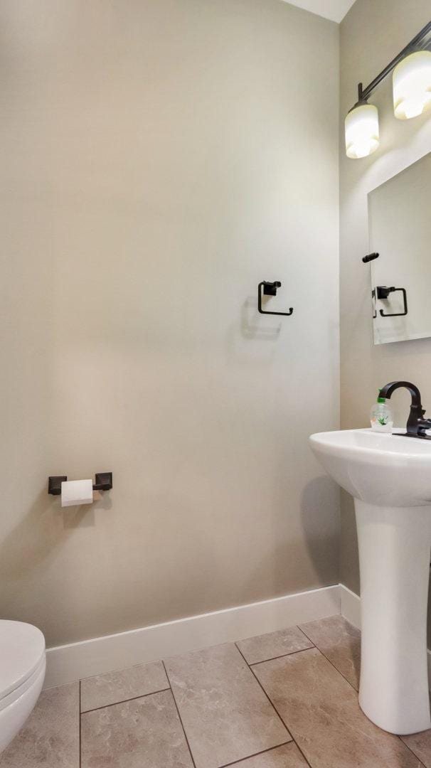 bathroom with tile patterned floors and toilet