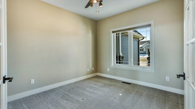 carpeted spare room featuring plenty of natural light and ceiling fan