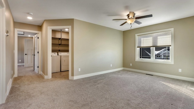 unfurnished bedroom featuring ceiling fan, washing machine and clothes dryer, and light carpet