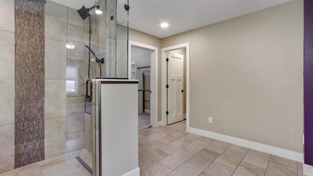 bathroom with tile patterned flooring and tiled shower