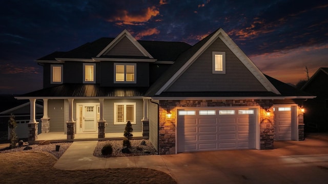 craftsman house with a garage and covered porch