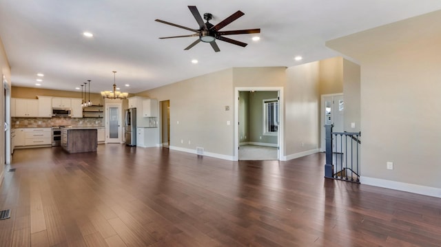 unfurnished living room with recessed lighting, baseboards, dark wood-style floors, and ceiling fan with notable chandelier