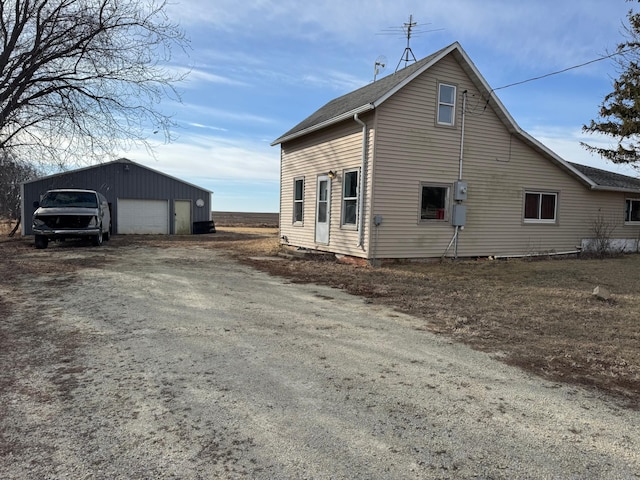 view of property exterior featuring an outbuilding and a garage