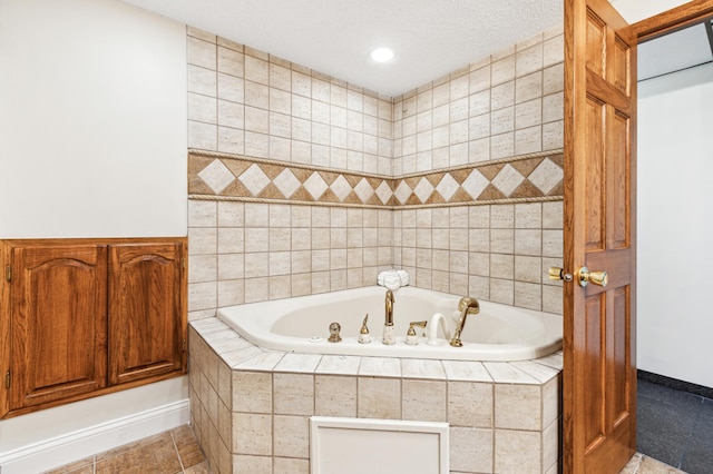 bathroom with tiled bath and tile patterned floors