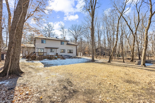 rear view of house with a wooden deck